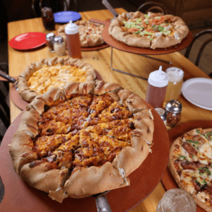 multiple pizzas on a table